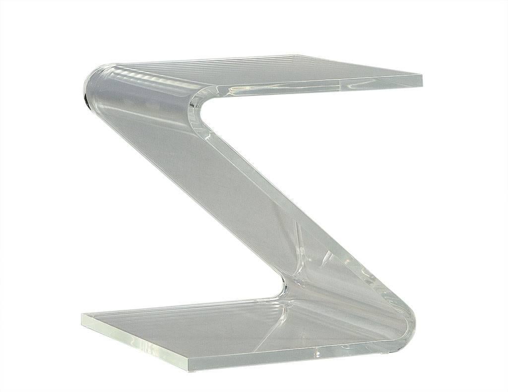 This perfectly unique z-shaped acrylic side table is attributed to John Mascheroni. According to the New York Times, Mascheroni once was synonymous with acrylic furniture because the modernist pieces he produced in the late 1960s and early 1970s. In