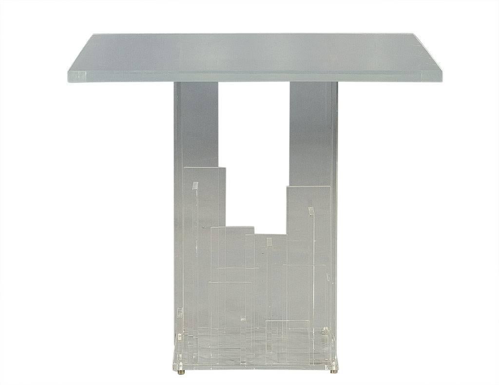 This innovative all Lucite side table has an open-sided pedestal base with interior geometric panels of various lengths. Try displaying books in a whole new fashion. A true statement maker for any living space.