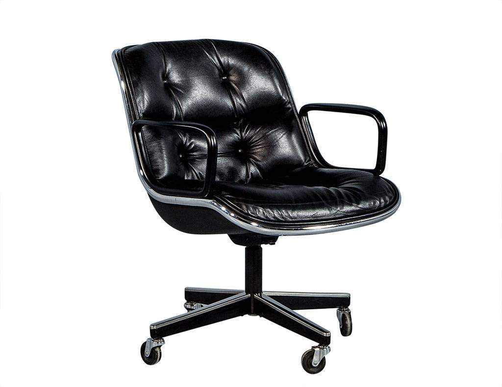 These office chairs are made of tufted black leather, with chrome accented legs and seats sitting on castors. The pairs are attributed to Charles Pollock and have low backs and plastic armrests. In excellent condition, these chairs are perfect.