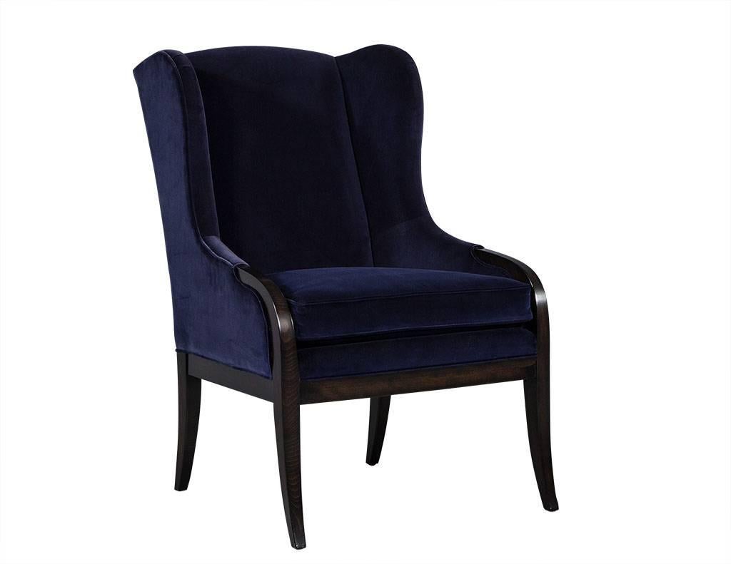 This transitional style chair is smartly designed and crafted. The frame is made of espresso-stained show wood and upholstered in a deep navy blue velvet. This wing back chair truly embodies comfort and flair and the perfect contrast for any living