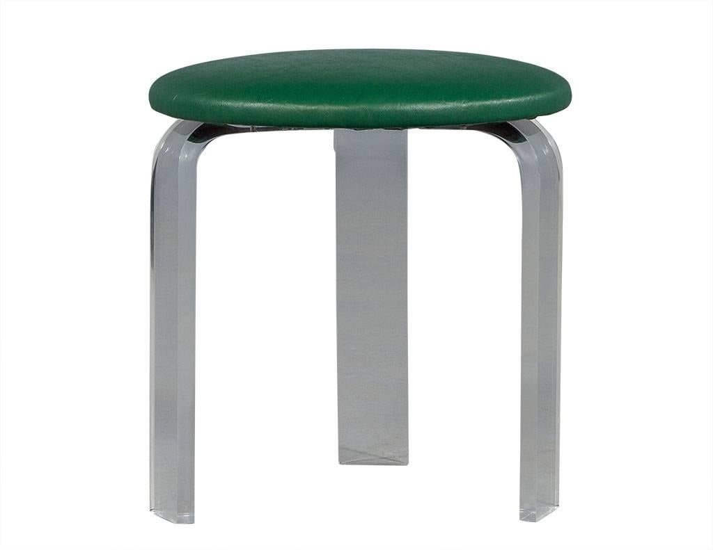 This Mid-Century Modern stool is attributed to the 1960s and truly has some pizzazz! The base is comprised of three curved acrylic legs and is topped with bright green vinyl. This piece is a great addition to any sitting area.