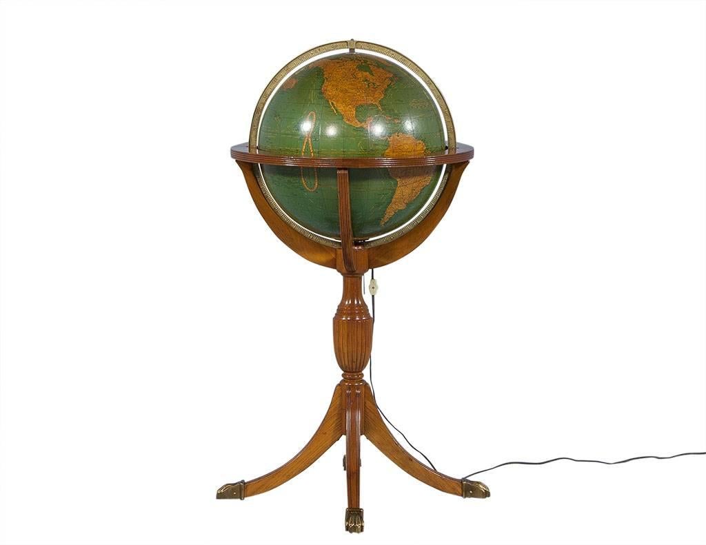 This traditional style floor lamp is certainly distinctive, with a Duncan Phyfe base and aged brass claw feet. The globe housed in the wood lights up and makes this an even more interesting piece of decor! A great addition for an office or study.