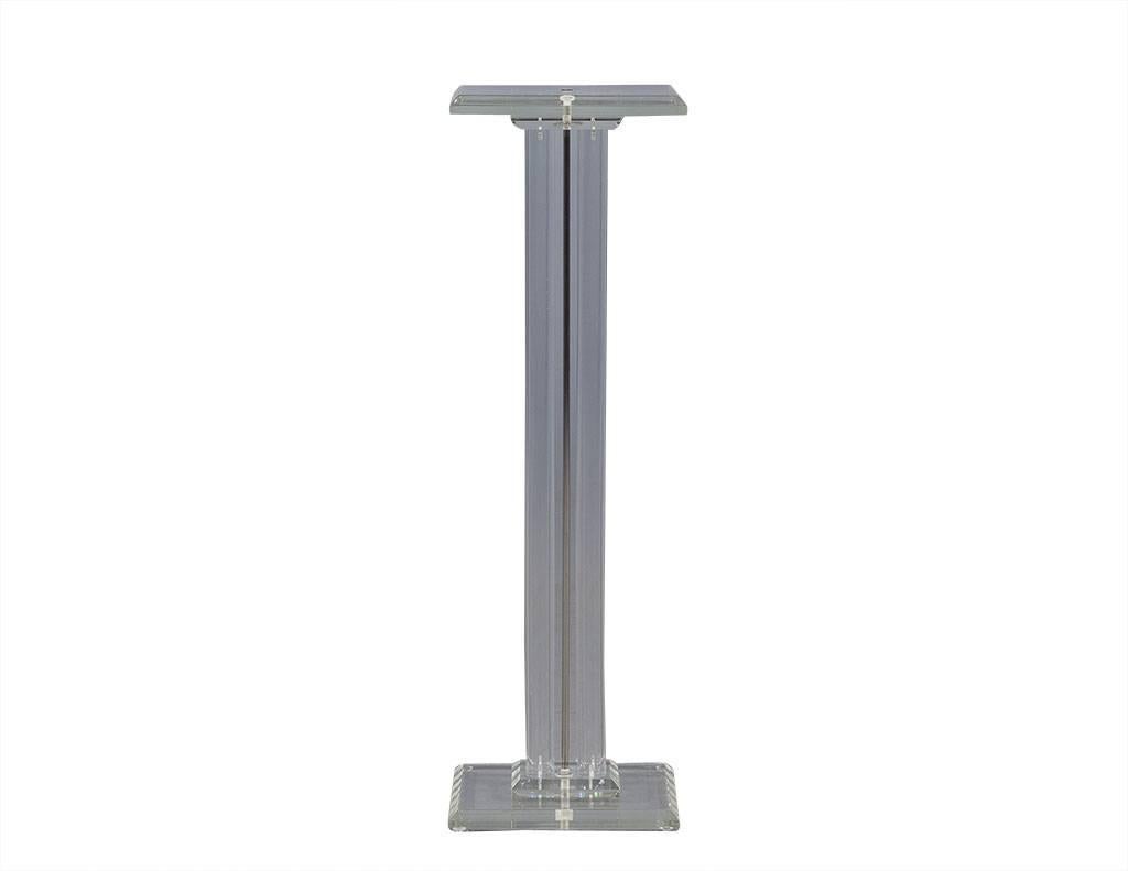 This Mid-Century Modern pedestal is a statement maker. It is expertly crafted out of four tubular Lucite columns with one chrome center column. Finished with beveled edges on the top and base, it is a great addition to any foyer or entryway!