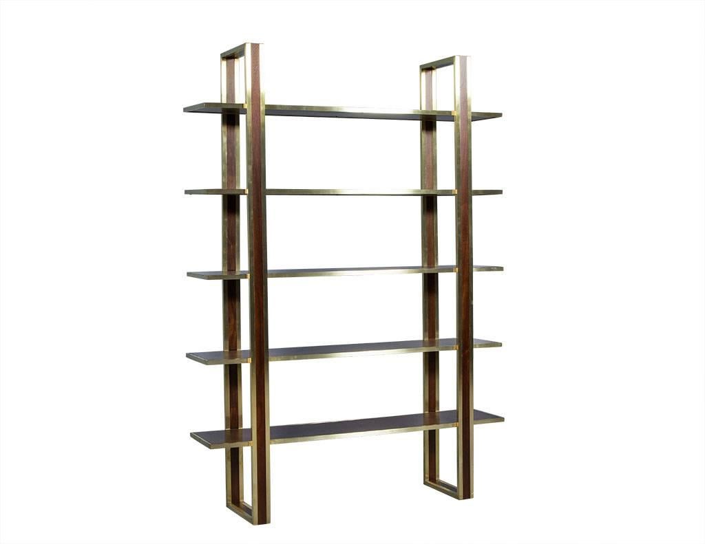 This Mid-Century Modern étagère is beautifully detailed and perfectly glossy. It is crafted out of mahogany in a sculptural design with five floating shelves and satin brass trim over all of the edges. A great fit for a sharp living area or foyer!