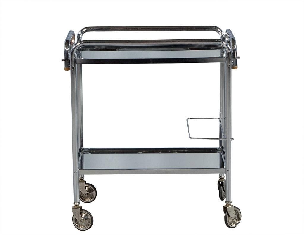 This Mid-Century Modern serving cart is definitely “serving up” some 1950s style. Comprised of two polished chrome tiers and mirrored glass shelves, this cart is perfectly understated and also mobile thanks to the fact that is sits atop four wheels.