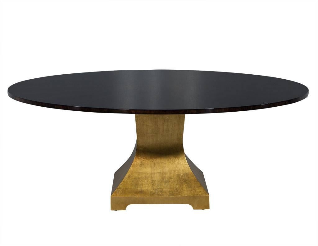 This contemporary dining table is a Carrocel custom piece. Crafted out of flamed mahogany in a starburst pattern and finished in highgloss, it sits atop a pedestal of gleaming giltwood. A beautiful addition to any dining room.