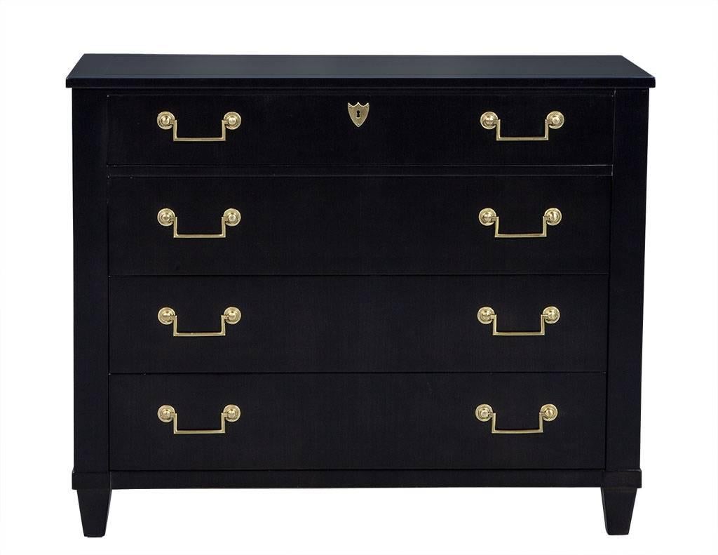 This traditional chest of drawers is the latest addition to the Carrocel Revival collection. It is a vintage baker chest refinished in fresh, satin black lacquer, leaving the original brass hardware and lock on the top drawer untouched. This piece