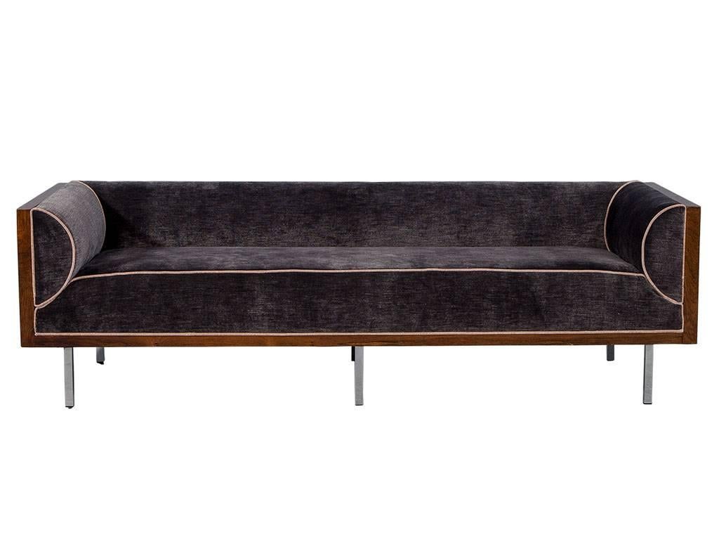 This Mid-Century Modern, Milo Baughman sofa is the latest addition to the Carrocel Revival collection! The beautiful rosewood frame comes in a natural finish and is supported by six slim chrome legs. Newly reupholstered in dark lavender velvet with