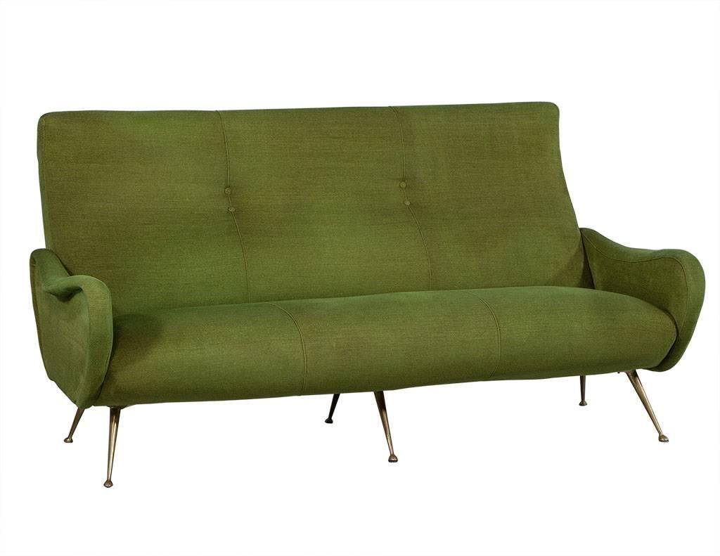 This retro moss green vintage sofa and two armchair set was designed in the style of Giò Ponti, made with a wooden frame, upholstered in the original velvet, with aged brass feet. Sofa accented with double tufting across inside back. A great