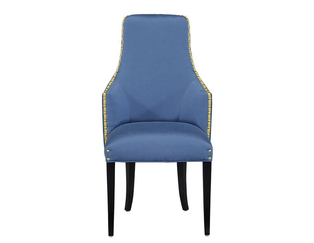 These traditional chairs are truly fit for royalty. They sit atop wooden legs finished in a matte black and have a high chair back with scalloped arms. The chairs are upholstered in a soft royal blue mohair velvet on the outside back with royal blue