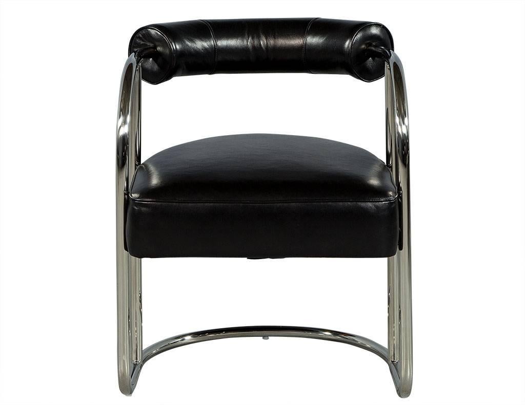 This Bauhaus inspired chair is simple yet luxurious. It is crafted out of a tubular stainless steel frame with a black leather seat and bolster style back cushion enveloping the frame. A cool addition to any modern sitting area!