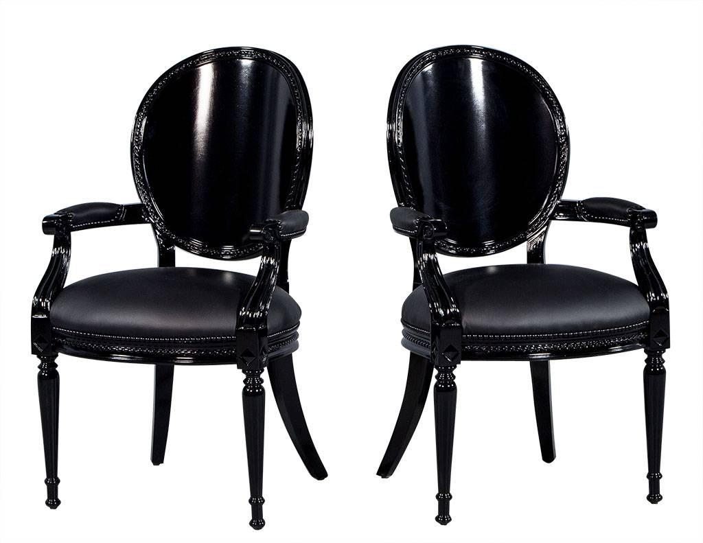 This set of eight dining chairs have been finished in a sleek black high gloss lacquer by the Carrocel team. The Louis XVI inspired mahogany frame features a curved, rounded back and is upholstered in a matte black leather, while a black nailhead
