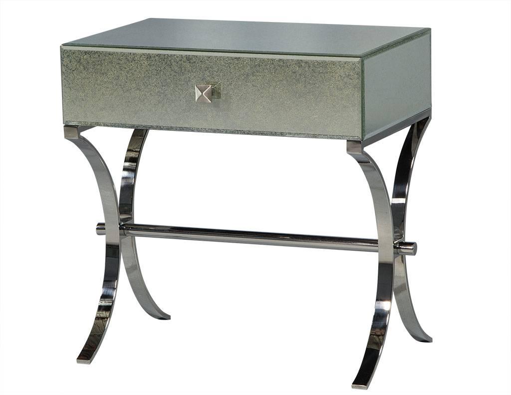 These traditional style nightstands are absolutely striking. They are composed of an antique-mirrored compartment with a single drawer accented by a square pull. They each sit atop a double Demilune, polished, stainless steel base. A gorgeous set