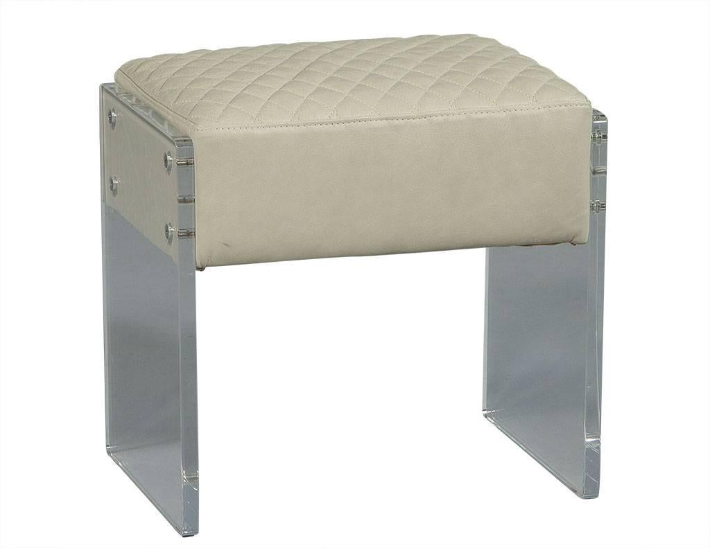 These modern stools are comfortable and chic. They are composed of a creamy, quilted leather top with a thick, Lucite panel base and are perfect for an elegant sitting area.