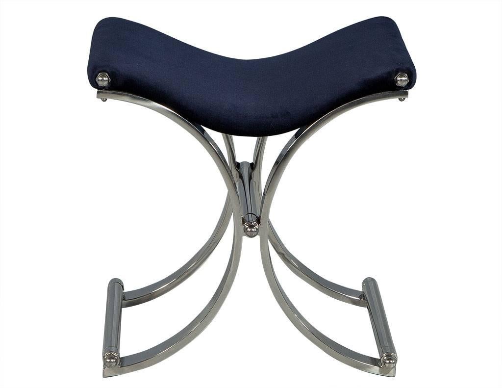 These modern stools are curvaceous and sleek. Each one has a curved seat upholstered in dark blue velvet sitting atop a brushed stainless steel, demilune base connected by a stretcher. A gorgeous set, perfect for a contemporary home.