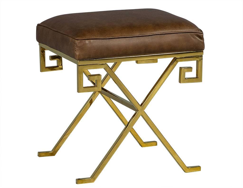 These modern stools are absolutely elegant. They each have a cognac colored leather top with a Greek key designed, X-base, polished brass frame. A perfect set for a richly designed home.
