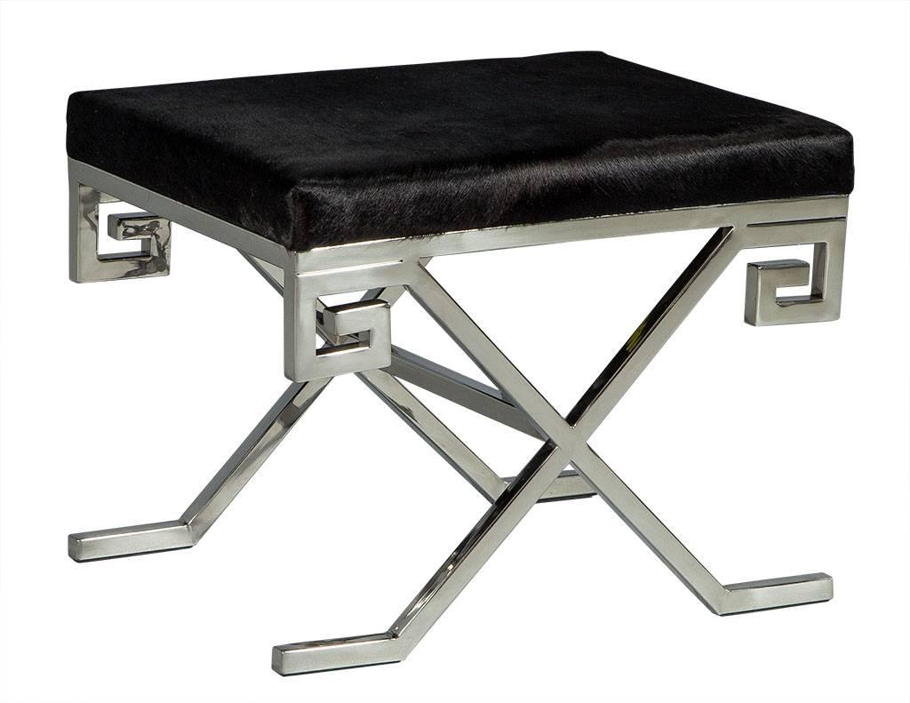 These modern stools are absolutely elegant. They each have a black cow hide top with a Greek key designed, X-base, brushed stainless steel frame. A perfect set for a richly designed home.