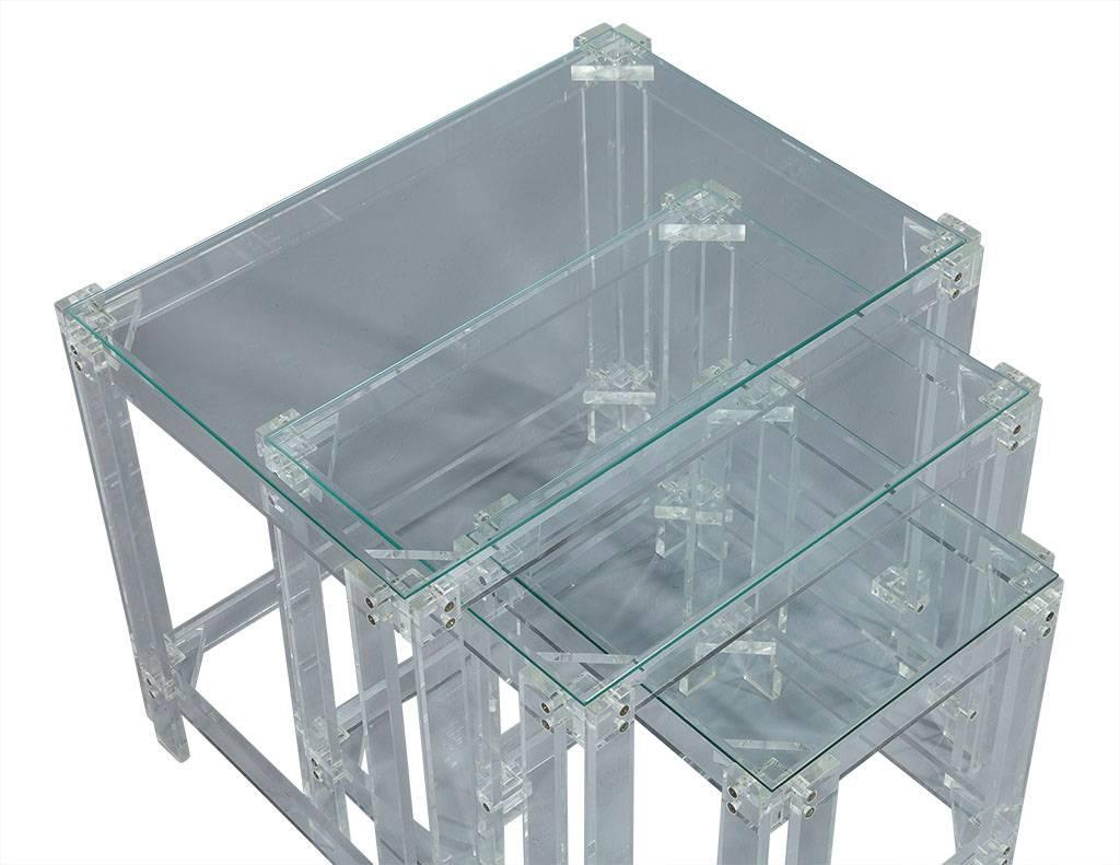 These Mid-Century Modern nesting tables embody the 1970s. They are comprised of a Lucite frame joined by connectors and a glass top. This statement set is the perfect fit for a daring living space!

Please note the Lucite is clear, the blue hue is