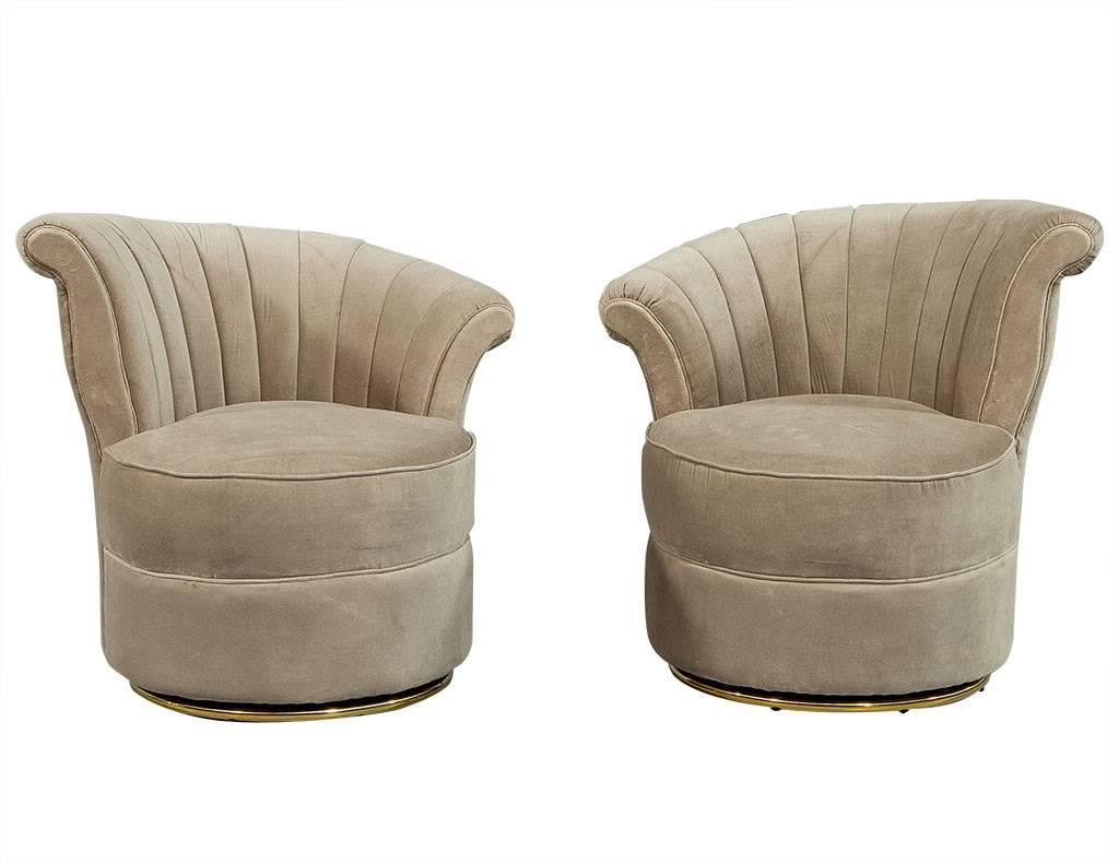 These occasional chairs are completely stunning. They are upholstered in a beautiful beige velvet and have a sloped, shell back and rounded seat. Each rests on circular brass allowing them to swivel freely. A perfect addition to a soft and serene