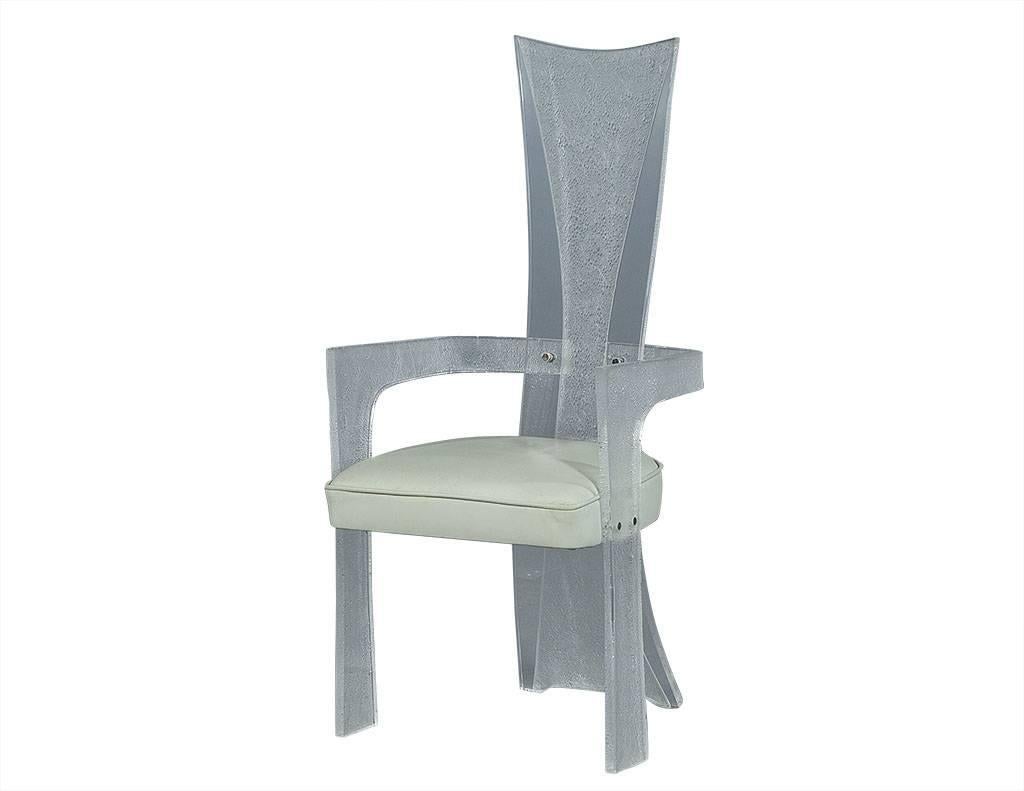 This armchair is sharp and utterly chic. Composed of clear and textured, frosted Lucite panels with a curved, narrow high back and curved arm rests. The box seat is upholstered in ivory-colored leather which adds a gorgeous contrast and comfort to