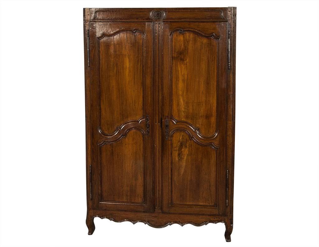Sample a fully functional armoire front that can infuse a regular wardrobe, entry or closet with all the classicism of the Louis XV style. A rich double door composition in wood, with carved recessed panels and iron long-bar hinges, and two drawer