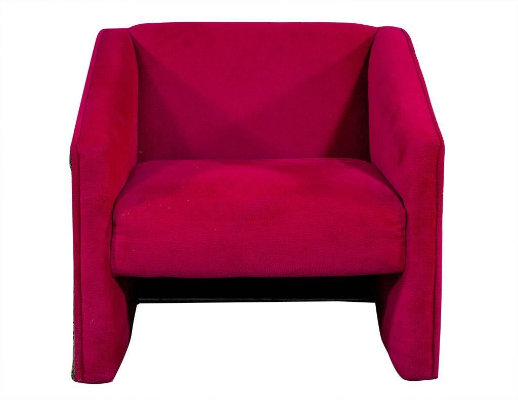 These Brutalist style arm chairs are designed by Adrian Pearsall.  His work is known for being flamboyant and eye-catching, and these chairs are certainly no different.  From the graphic, resin frame to the bright fuchsia velvet upholstery, this
