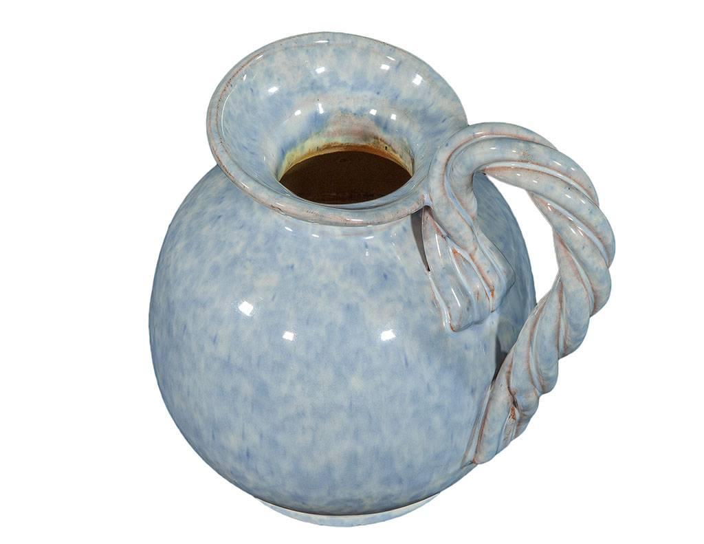 Pale blue glazed ceramic pitcher with a spiral handle design by Alexandra de Wemmel, signed.
 