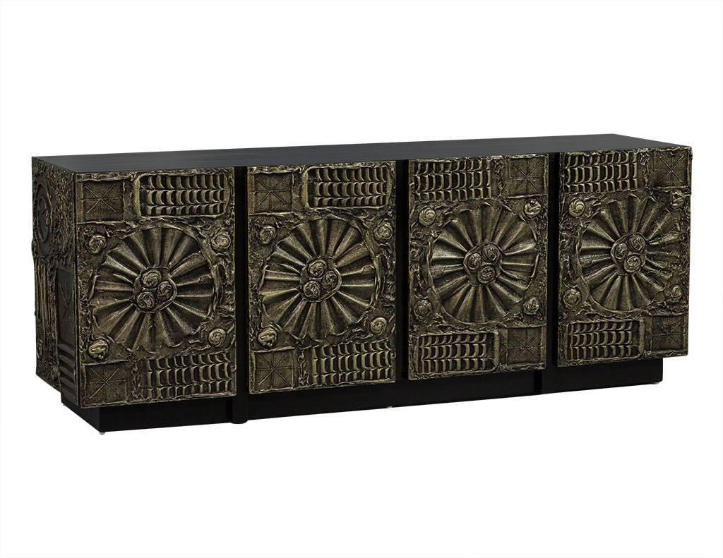 This Brutalist style sideboard is designed by Adrian Pearsall. His work is known for being flamboyant and eye-catching, and this piece is certainly no different. Framed in signature, graphic, resin finished in bronze, the four door buffet conceals