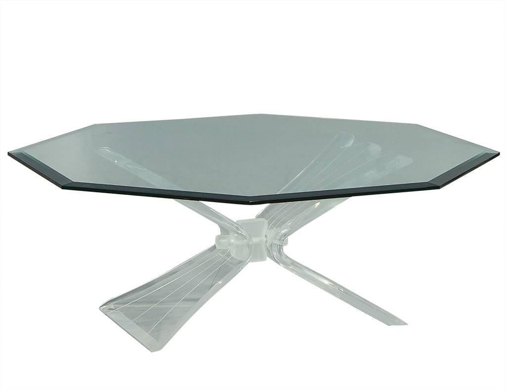 Stunning vintage Hollywood Regency style cocktail table attributed to the design from Lion in Frost. With a butterfly pedestal and thick, octagonal, beveled edge glass top this piece is a defining design from the Mid-Century era. In excellent