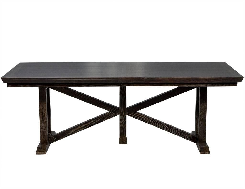 This modern dining table is crafted out of solid oak. It has an X-base, cross bar, plank base and comes with a 24” leaf. Finished in a dark grey stain, it is the perfect match for some trendy mismatched chairs.

Table fully extends to length of