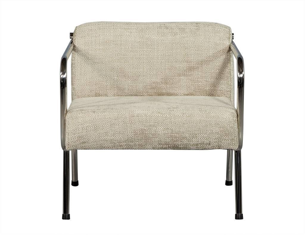 These Mid-Century Modern armchairs are part of the Carrocel custom collection. They sit atop a tubular chrome frame with a wide seat, and plush, creamy woven chenille fabric upholstery. A truly gorgeous addition to any living room.