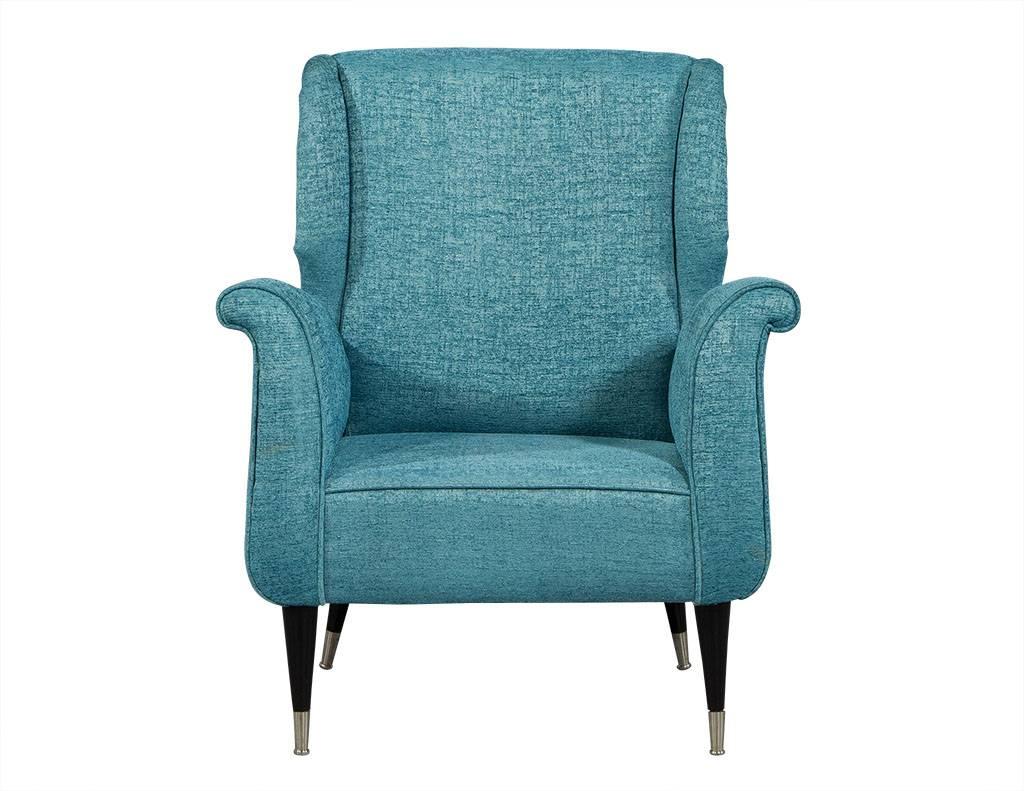 These Mid-Century Modern armchairs are truly a dream. Carrocel originals, they are in great shape with just a bit of wear consistent with age and use. The upholstery is a gorgeous teal silk fabric with contrasting dark wood legs with silver tips. A