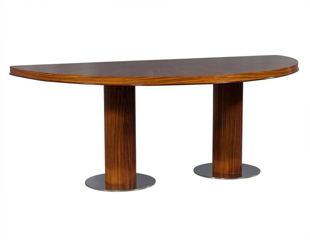 Half table composed of wood veneer in a starburst pattern on a double cylindrical posts on circular chrome bases. 
Glossy, medium walnut finish.