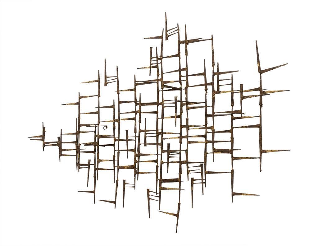 This modern wall sculpture is a simple yet beautiful piece. It is comprised of linear groupings crafted out of brass burnished bronze. Perfect for adding texture to a contemporary home. 
 