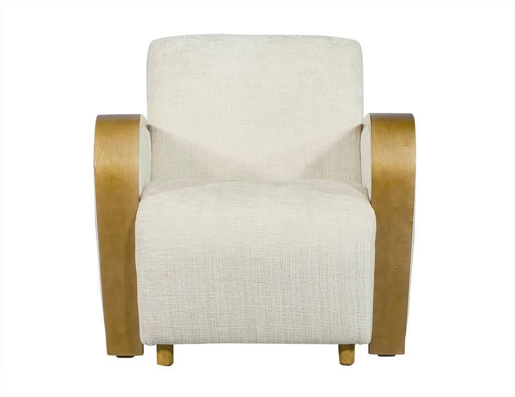 These Art Deco mixed-media armchairs are truly striking. Newly restored and upholstered with stain repellent fabric and are in excellent condition. Each chair has wide, medium brown lacquered wood armrests in a waterfall style to the front, and sits
