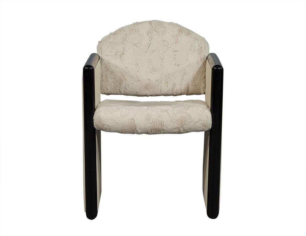 This Modern accent chair is truly one of a kind. Featuring a very soft faux fur seat with square sides in cream leather trimmed with black lacquered wood. The interested mixed media concept makes this chair a unique addition to a daring home!