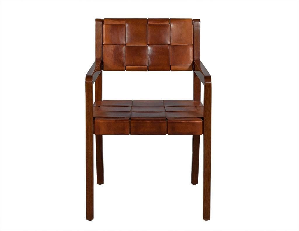 This modern desk chair frame is composed of solid mahogany polished in a shiny lacquer with a seat and backrest wrapped in wide, interwoven leather trips. An interesting piece perfect for a rustic home.
