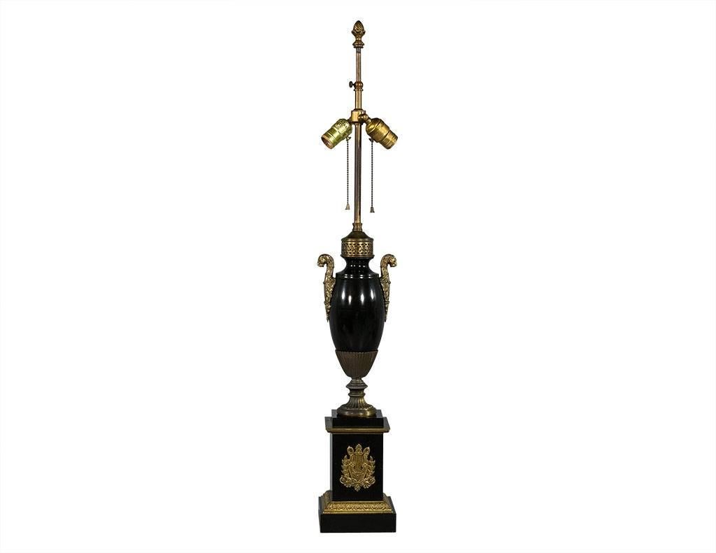 These Regency antique table tamps are beautifully ornate. They are each comprised of a black metal centre section and base with bronze designs and detailing. Fitted for two bulbs and customizable with your choice of lampshade, these lamps are