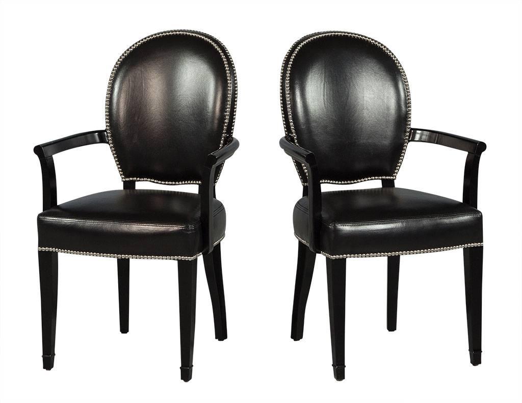 Set of eight Deco inspired dining chairs, upholstered in black Italian leather with saddle stitched seats with head to head hand applied nickel nailhead trim. (set consists of two armchairs and six side chairs)

Measures: Armchair: 37.5” W: 22.5”