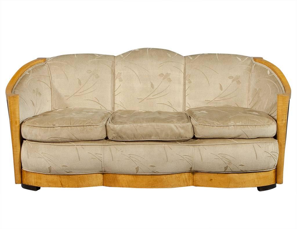 This vintage Art Deco parlor set hails from France. The sofa and matching chairs are original pieces that just need to be reupholstered. Featuring a light coloured wood frame with dark wood dowel rods on the back and sides. Perfect for a richly