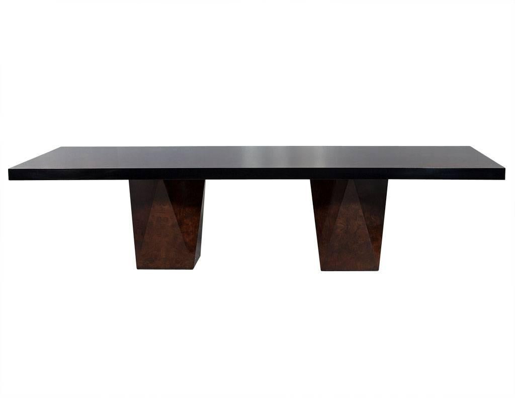 This made to order dining table is part of the Carrocel Custom collection. It is crafted out of beautifully matched burl walnut with a matching border. The top is hand polished for a deep, high gloss luster with an ebonized black edge. The piece