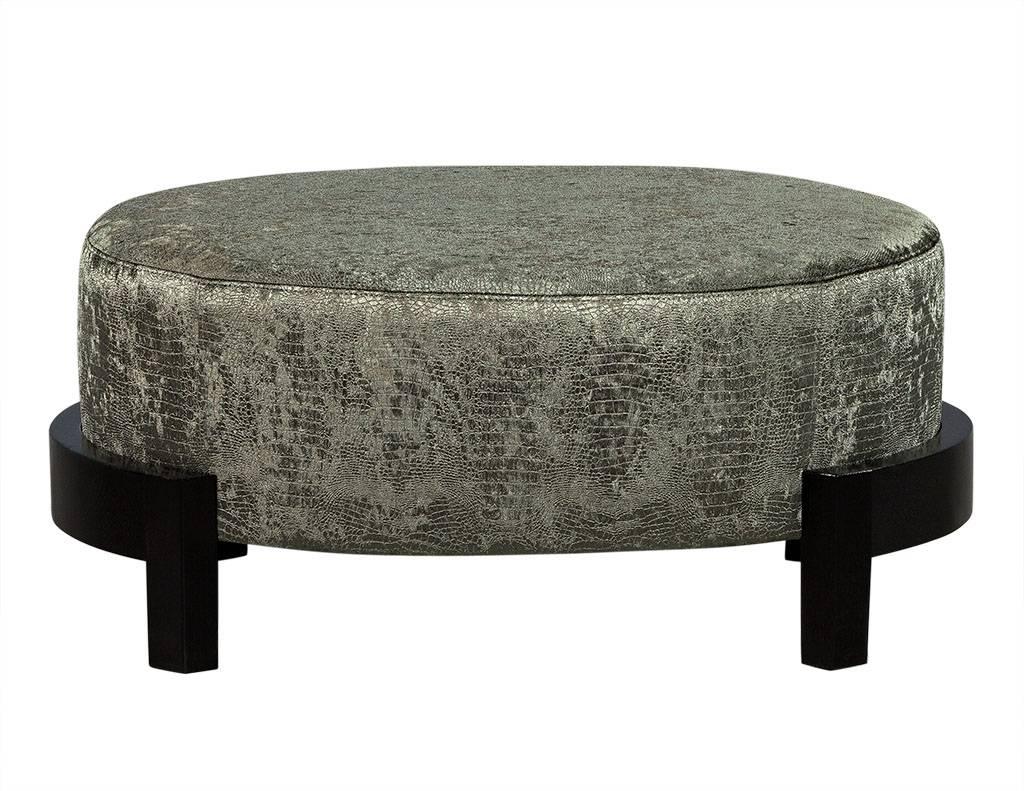 This transitional style ottoman is newly restored. A large piece, it is reupholstered in sage green velvet and sits atop curved wood legs wrapping around each end of the ottoman. Perfect for a sophisticated home!