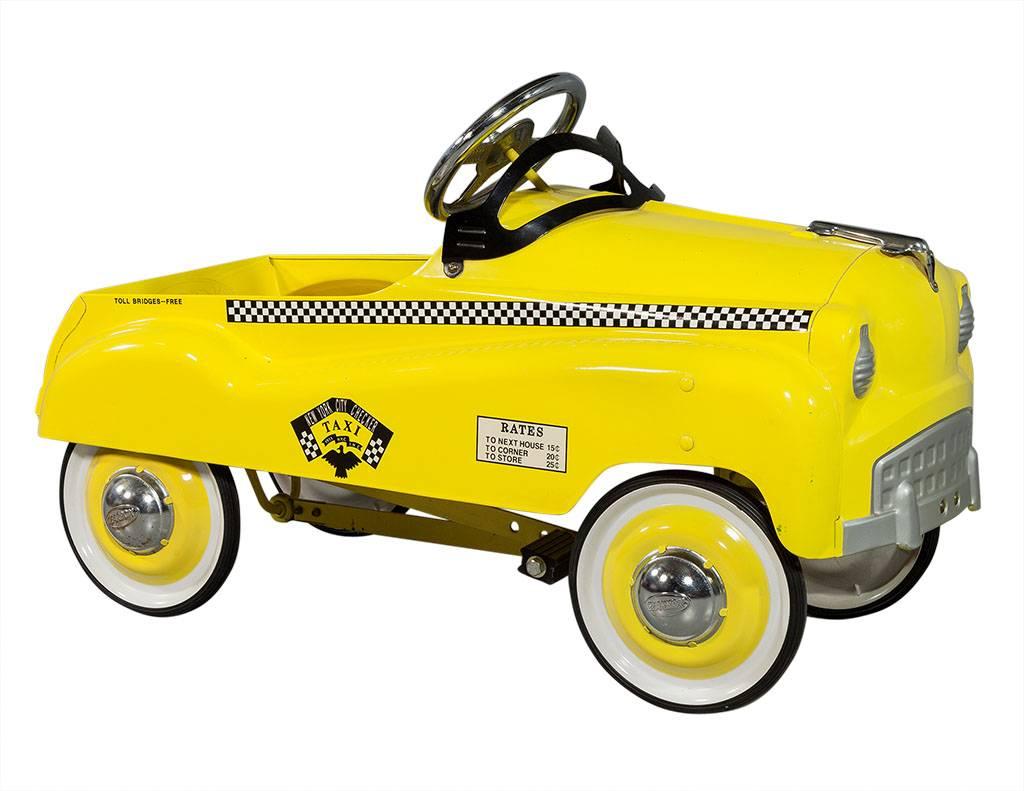 yellow taxi pedal car
