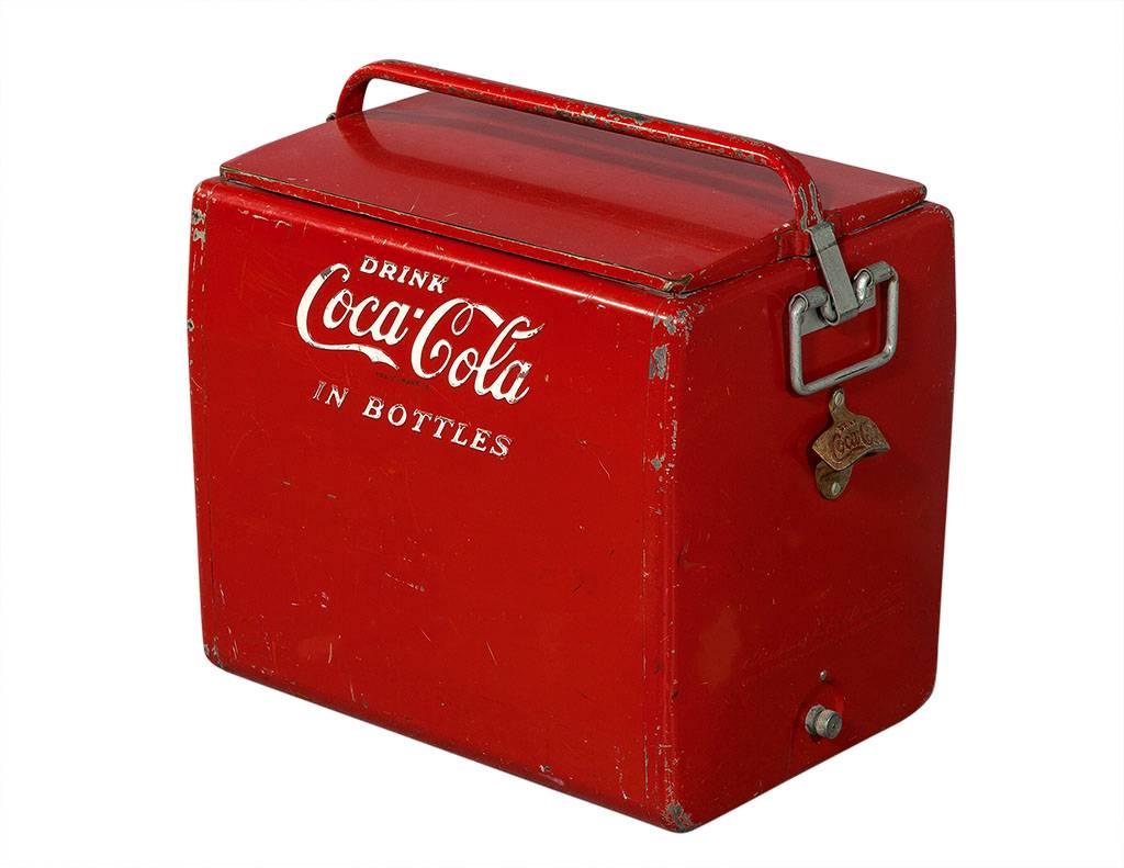 This bottle cooler is super retro, it has “Coca-Cola in bottles” written on the front in red and white. With an aluminum ice tray inside, the cooler is still functional but can also act as a piece of old-fashioned décor!