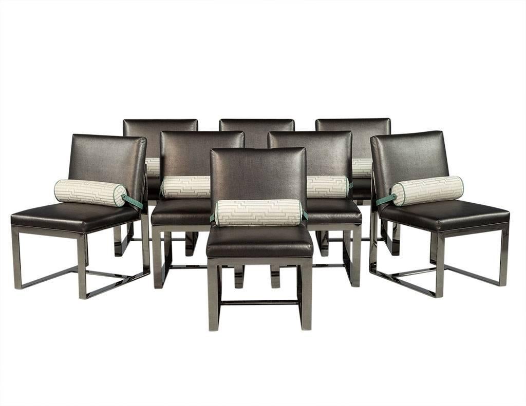 Set of Eight chrome dining chairs. Featuring a sleek modern chrome frame design. Set of optional lower back rolls included, in a beige and silver pattern with seafoam green leather edging and strap with easily removable snap connectors. Chair fabric