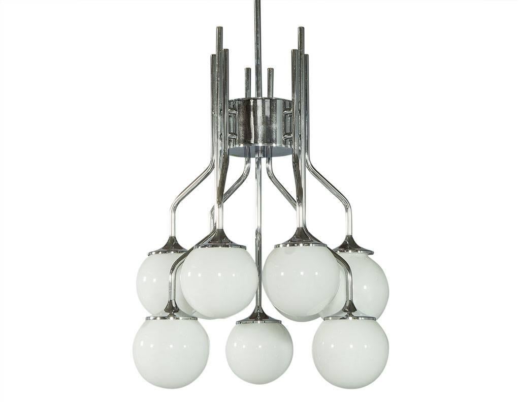 This Mid-Century Modern chandelier is composed of eight-light globes and a chrome frame, the vintage style makes it perfect for adding some 1980s flair to any home!