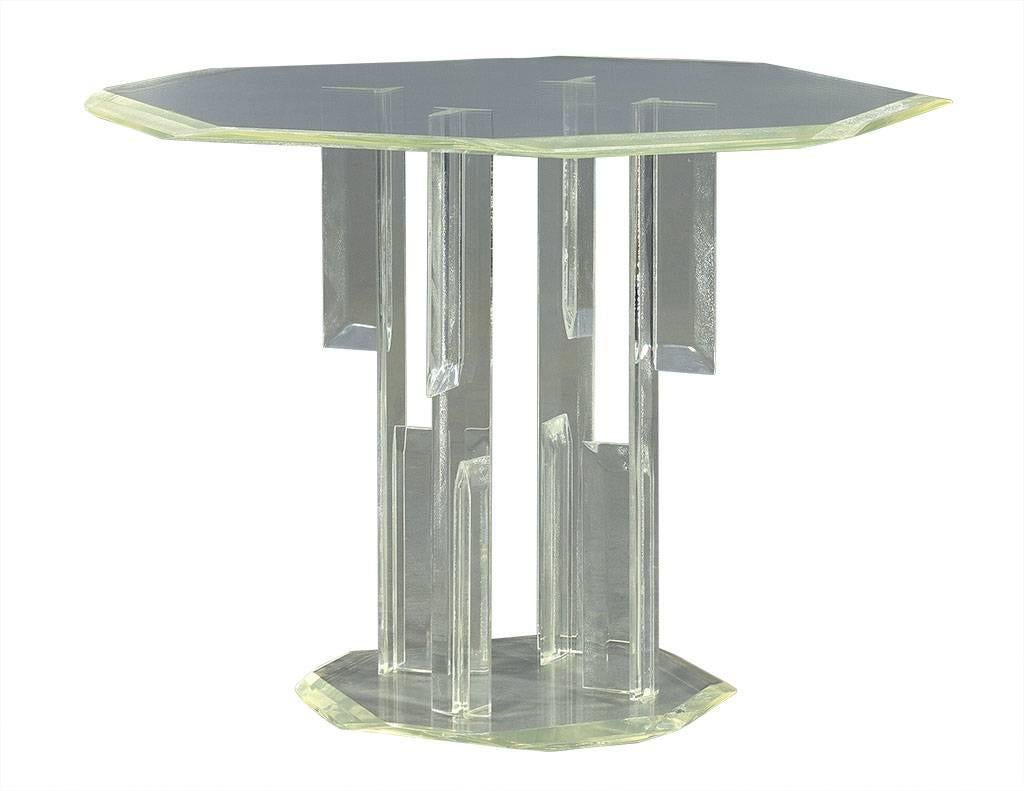 This ultra-modern end table is is octagonal in shape with a beveled table top and base connected by 4 lucite support posts.  A unique piece with plenty of 70’s flair, perfect for a bold home.