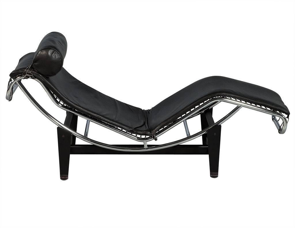This intricately designed chaise is attributed to Le Corbusier, it is crafted out of black leather with a padded roll headrest for comfort. Sleek in design, the black metal base is a perfect complement with a polished stainless-steel frame to match.