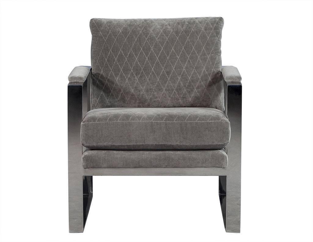 These contemporary lounge chairs are absolutely luxe. They sit atop stainless steel square frames and the non-removable seat and back cushions are upholstered in a light grey velvet with a diamond-shaped stitched pattern. Perfect for any sitting