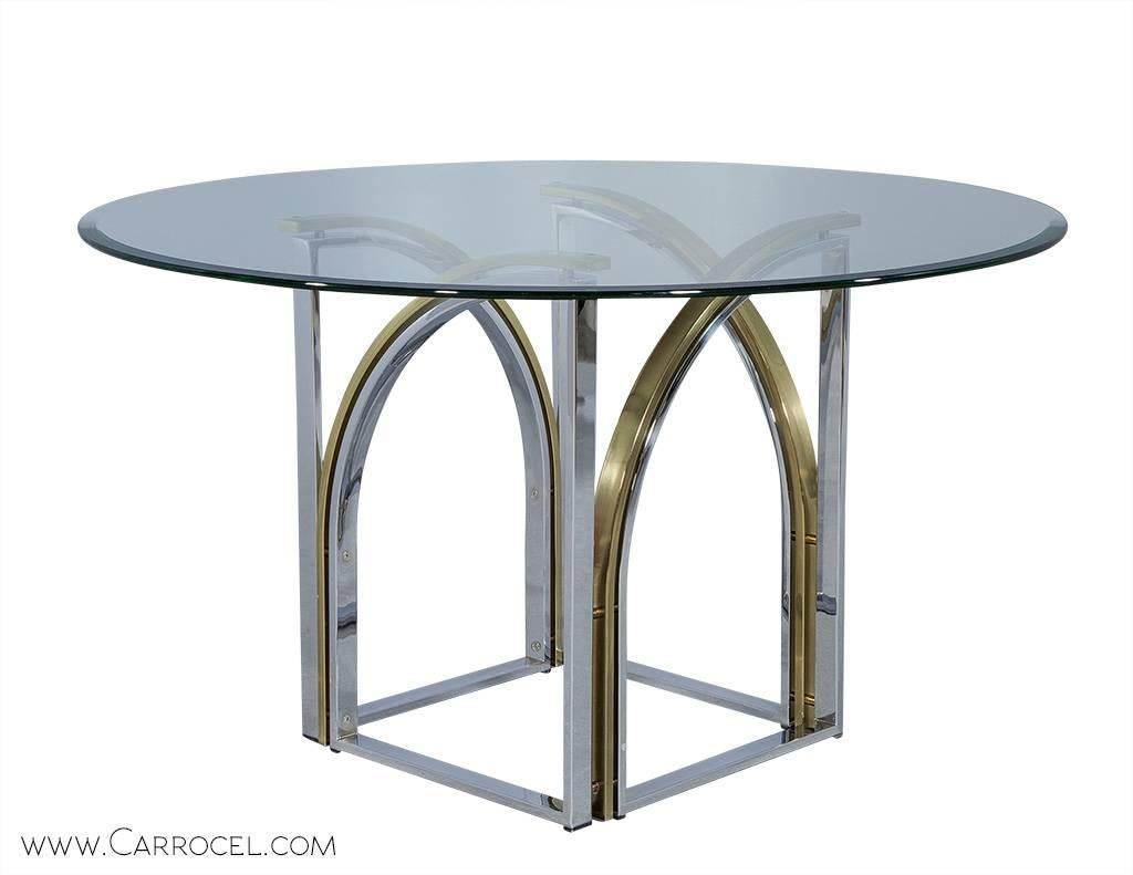 Mid Century sculptural table, designed with curved polished brass and chrome to create an extremely unique base. Imported directly from Paris, France. The brass and chrome are in excellent condition with minor scratches and markings on the base and